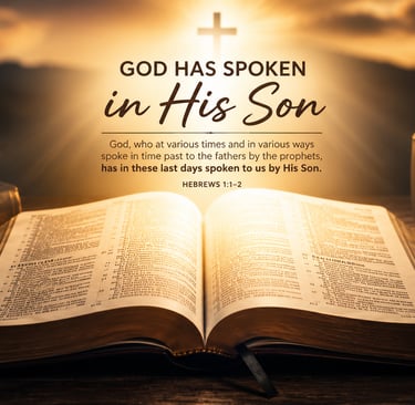 Open Bible on a wooden desk with Hebrews 1:1-2 scripture text over a glowing sunset background.