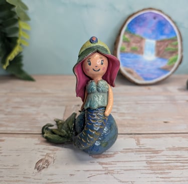 Sculpture of a mermaid sitting on a boulder