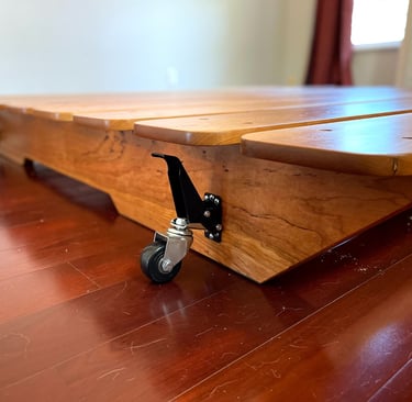 a wooden table with wheels and wheels on it