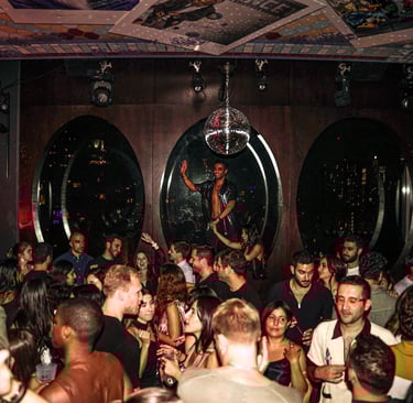 a man in a crowd of people standing around a disco