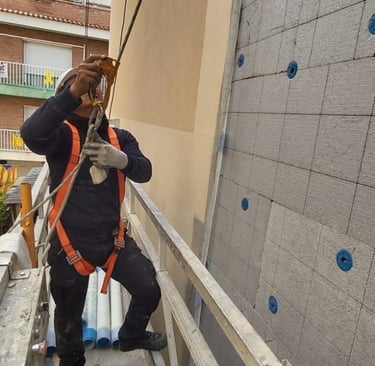a man in a safety vest is taking a picture of a man in a safety