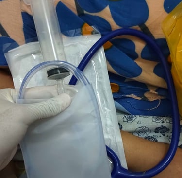 someone wearing gloves and holding a feeding tube