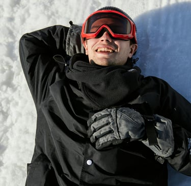 a man laying on his back in the snow