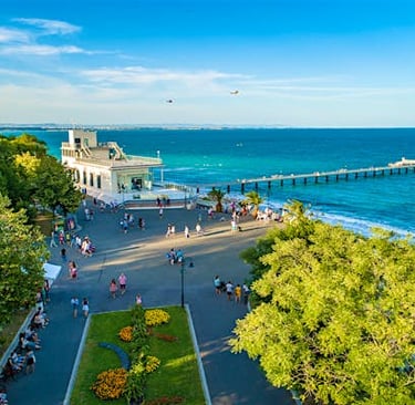 a view of a beach with people walking around