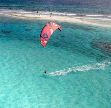 Kitesurfer on the ocean, symbolizing presence, patience, and flow in mindful practice.