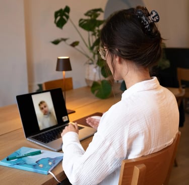 Psychologist at desk in video call with client on laptop, online psychological counseling