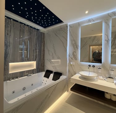 a bathroom with a tub tub and a large mirror