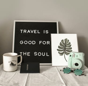 a sign that says travel is good for the soul