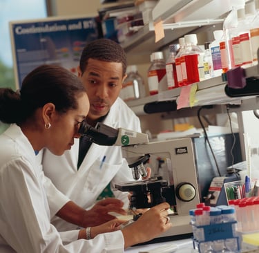 a female researcher observing under a electron microsope