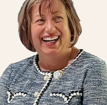 The head and shoulders of a woman with green eyes and short, light brown hair is smiling.