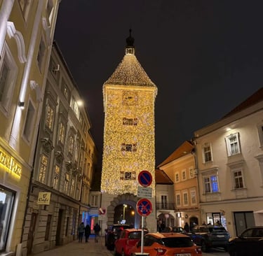 The illuminated Ledererturm tower in Wels, Austria, at night during the Christmas market season, sur