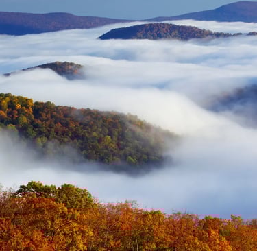 a mountain range with a view of the clouds