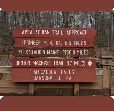 a sign post with a trail marker and a trail marker