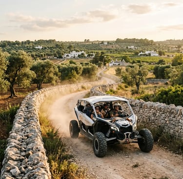 White off-road buggy with four passengers on dusty track between stone walls in Puglia