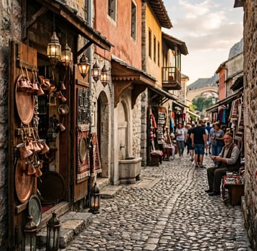 Cobblestone bazaar street in Mostar old town with copper coffee pots, lanterns and Old Bridge in view