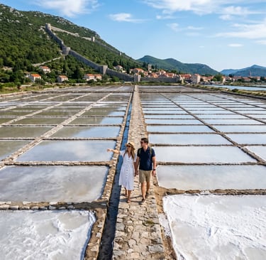 Couple walking through the ancient Ston salt pans below the medieval walls, Croatia