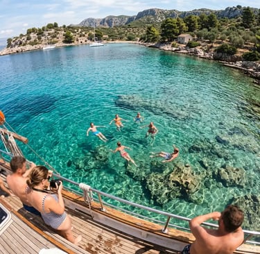 Group swimming in crystal-clear turquoise water of Fumija Bay near Split Croatia from boat deck