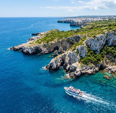 Drone shot of white limestone cliffs and tour boat sailing along Puglia coast