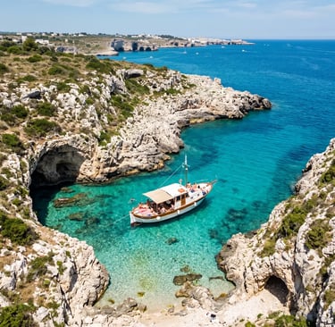  Drone shot of white boat in turquoise cove surrounded by white limestone rocks Puglia