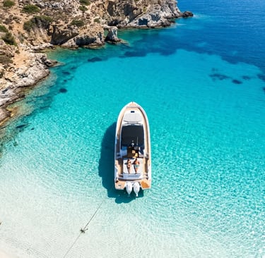 Premium speedboat cruising toward Kleftiko white volcanic cliffs in Milos at golden hour sunset