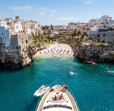 Luxury yacht anchored at Lama Monachile cove in Polignano a Mare with turquoise Adriatic water