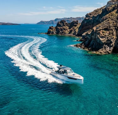 Aerial view of Saxdor 320 GTC speeding along volcanic coastline in Milos Cyclades