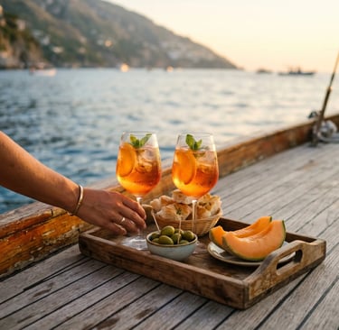 Wooden tray with two spritz glasses, olives, focaccia and melon slices on boat deck by the sea.