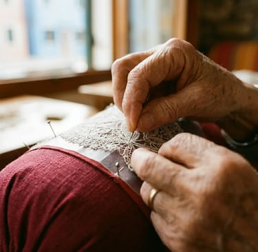 Elderly artisan hands stitching traditional Burano needle lace in natural window light
