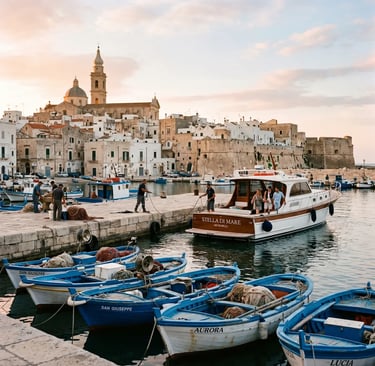 Historic Monopoli old port at sunrise with blue fishing boats and whitewashed Apulian old town