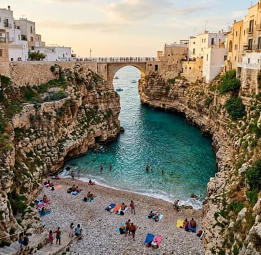 Lama Monachile cove beach framed by cliff walls and historic bridge in Polignano a Mare