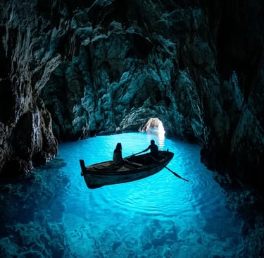Small boat inside Blue Cave on Biševo Island with glowing blue water
