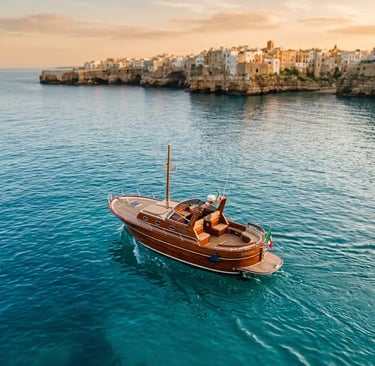 Handcrafted Fratelli Aprea boat on turquoise Adriatic Sea near Polignano a Mare at golden hour