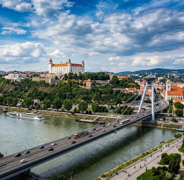 Bratislava Castle on hilltop above Danube River with UFO Bridge and city skyline below