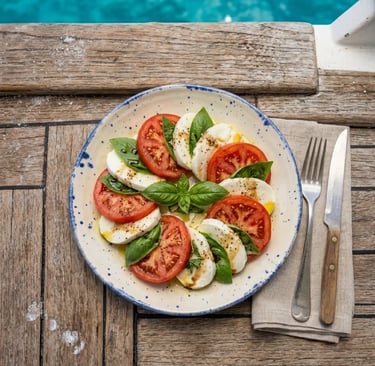 Fresh Caprese salad served on a rustic dish on the boat deck above turquoise Capri water
