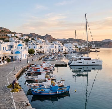 Traditional Pollonia harbor in Milos Greece with fishing boats and luxury catamaran at sunrise