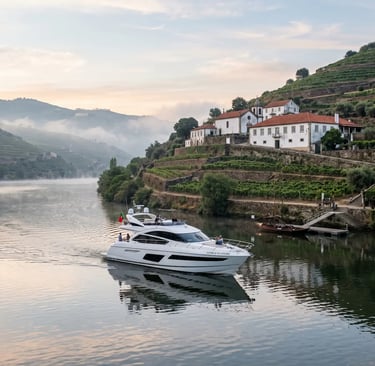Estrela do Douro yacht docked near historic Portuguese quinta on misty morning Douro River cruise