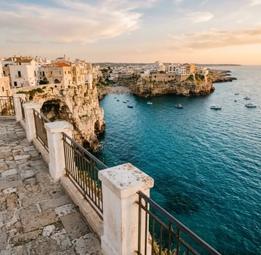 Clifftop terrace viewpoint in Polignano a Mare overlooking turquoise Adriatic Sea at sunset