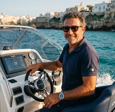 Professional Italian captain steering brand new private boat along Polignano a Mare coast