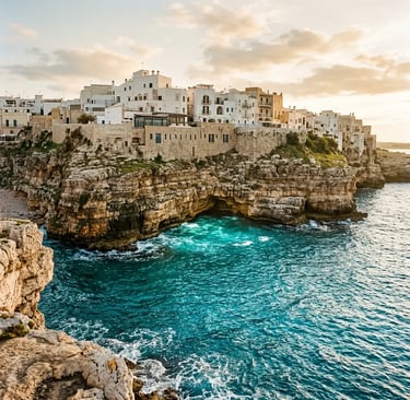 Polignano a Mare whitewashed buildings on limestone cliffs above Adriatic sea cave