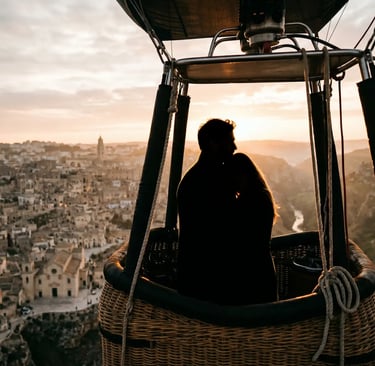 Couple silhouette embracing in balloon basket above Matera Sassi at golden sunrise light