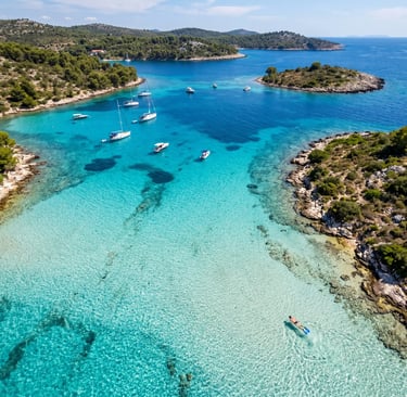 Aerial view of crystal-clear turquoise Blue Lagoon, Croatia, snorkeler below