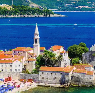Aerial view of Budva medieval old town with orange rooftops and turquoise Adriatic sea