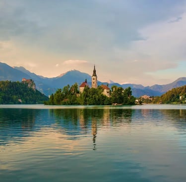 Peaceful Lake Bled with island church reflection and Julian Alps in background, Slovenia