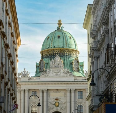 Vienna Hofburg Palace green dome framed between buildings on a sunny day