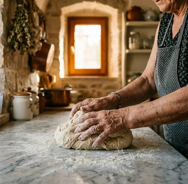 Elderly Italian woman kneading bread dough on marble counter in a traditional Bari stone kitchen