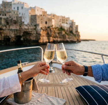 Couple toasting prosecco on private boat deck with Polignano a Mare cliffs in background