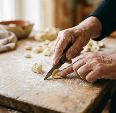Experienced hands shaping fresh orecchiette pasta with knife on rustic wooden table in Lecce