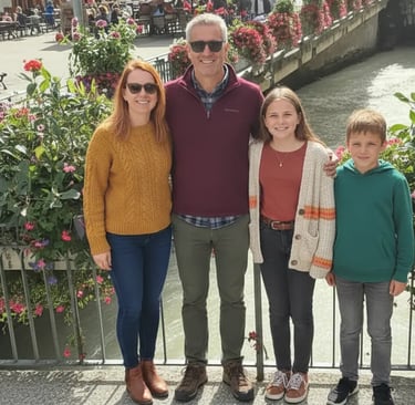 Family standing on a bridge in Chamonix town center with flowers, enjoying a sightseeing stop on a M