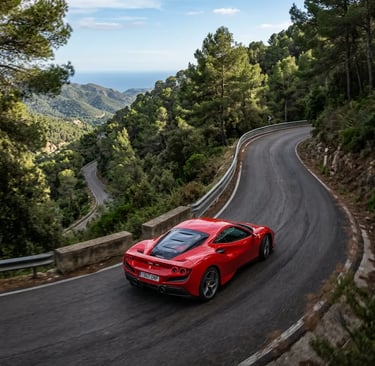 Red Ferrari driving a mountain switchback in Garraf Massif with Mediterranean sea view