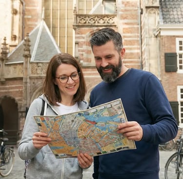 A happy couple using a map for things to do in Graz during their private walking tour.